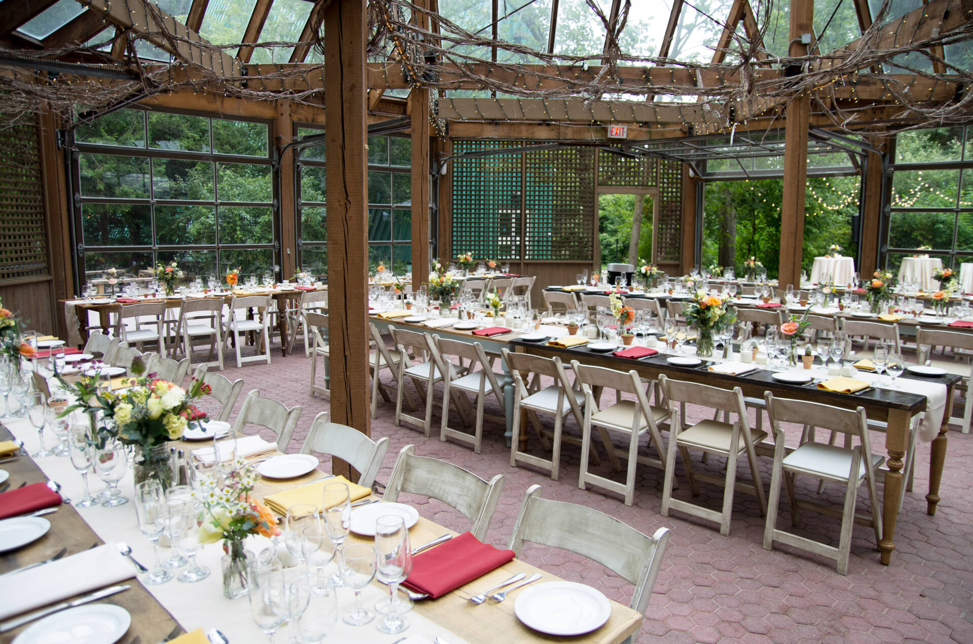 fully dressed tables setup in the Glass house of the kortright centre for conservation