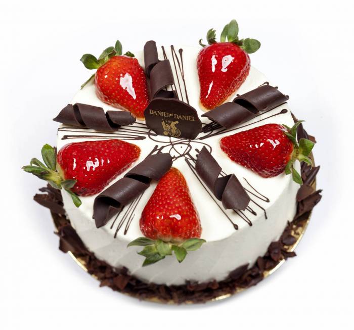 strawberry shortcake with fresh strawberries and chocolate swirls on top