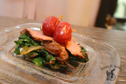 Thinly sliced duck breast over kale tossed with caramelized onion, topped with house-made raisins.